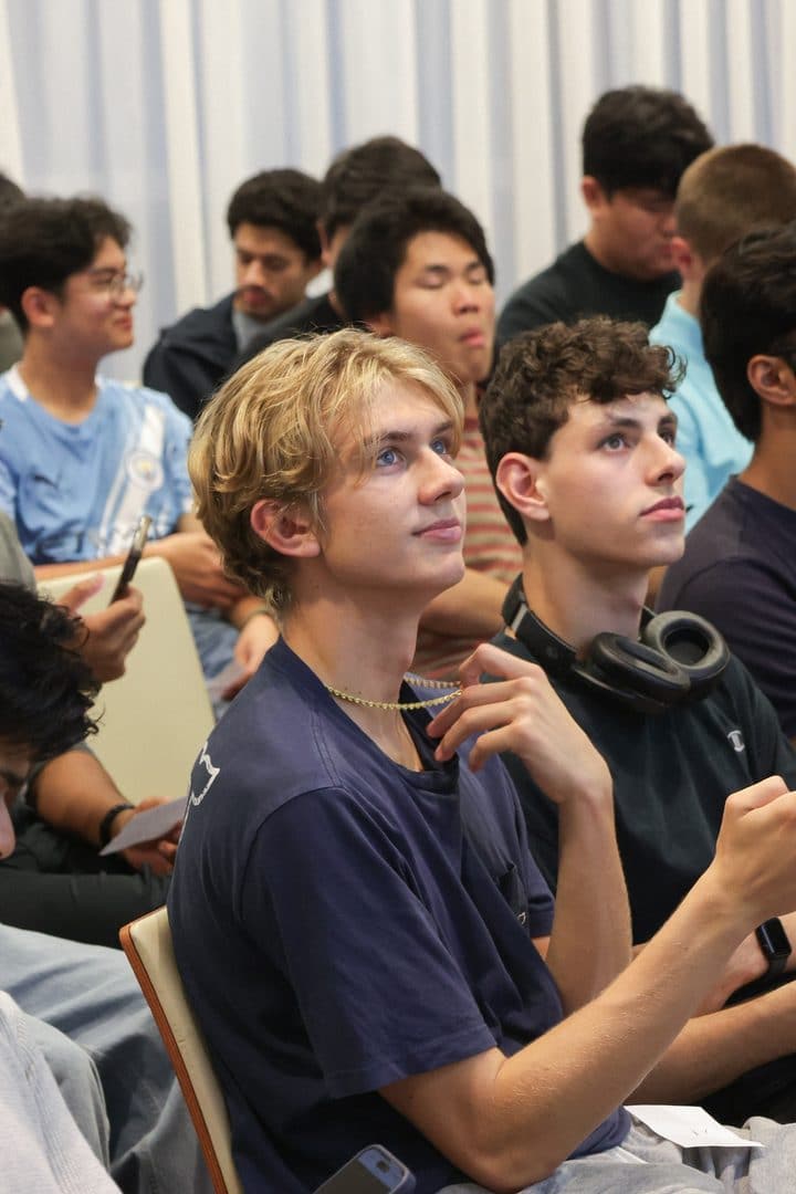 Students in the audience looking up at the slides.
